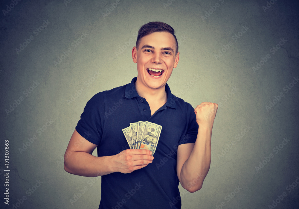 Happy man with money isolated on gray background Happy man with money isolated on gray background