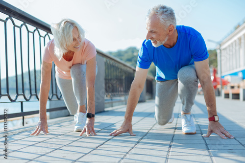 Cheerful senior couple being in starting position photo
