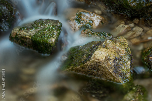 Water Flowing Over Mossy Rocks