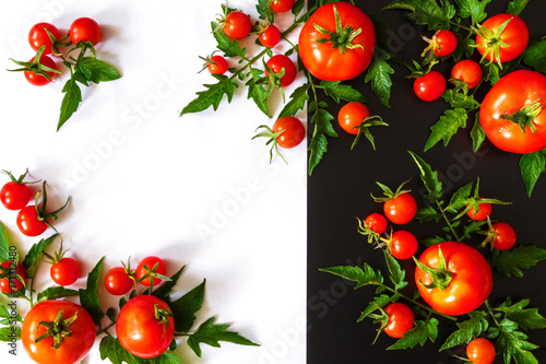 Fresh juicy tomatoes  cherry and leaves pattern and ornament on a black and white background with copy space flat view from above and place for text