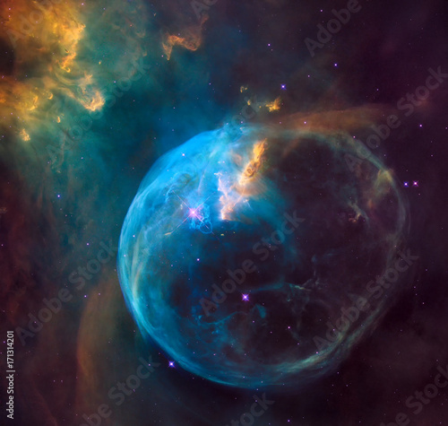 enormous bubble being blown into space by a super-hot, massive star. Hubble image of the Bubble Nebula. Elements of this image furnished by NASA.