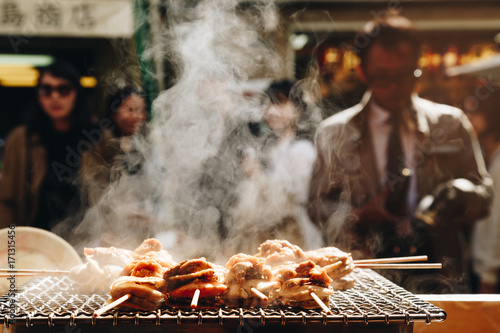 Quadro su tela grilled seafood scallop and sea ​​urchin eggs skewer with smoke, japanese street food at Tsukiji Fish Market, Japan