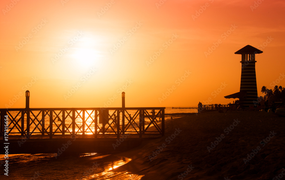 Sunset over the sea. Pier on the foreground. Panorama