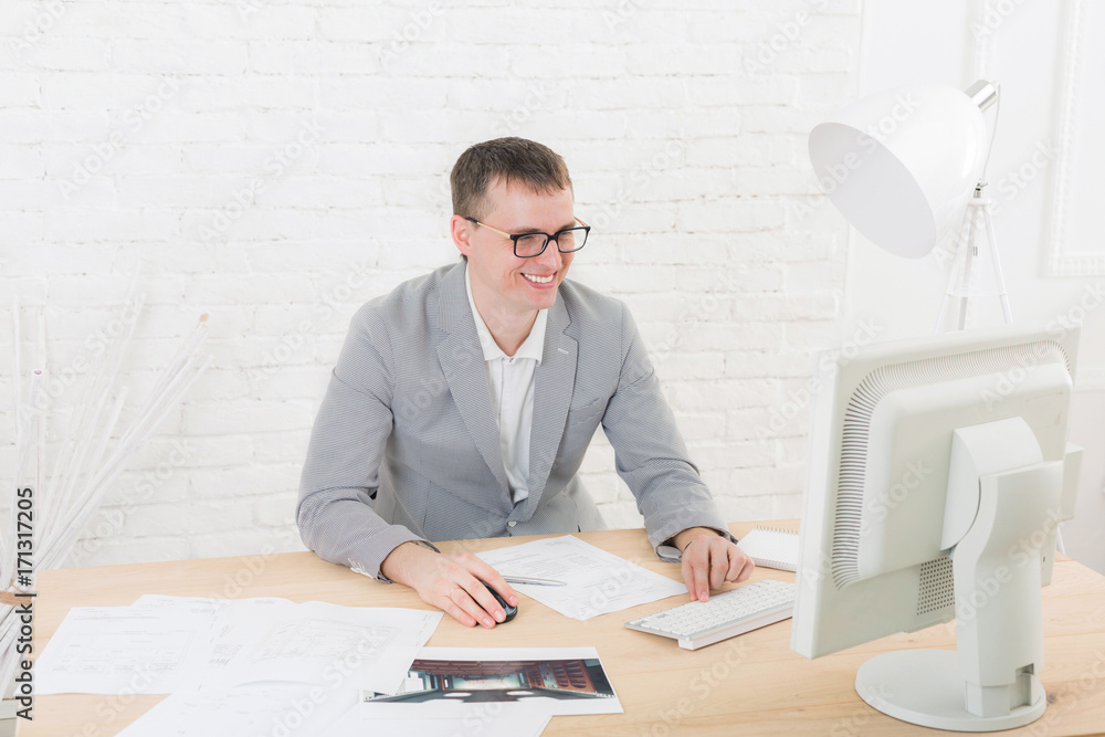 Young businessman in office with computer Young businessman in office with computer