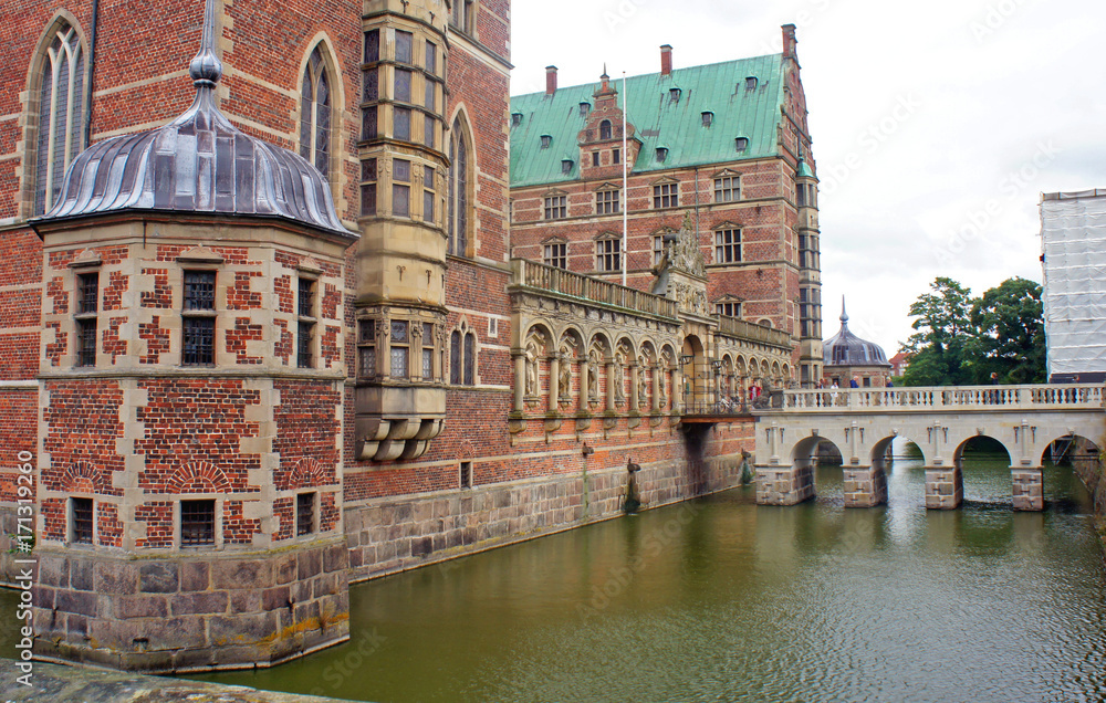 Brick wall, bridge and decoration with sculptures at Frederiksborg Castle, the largest Renaissance residence in Scandinavia, cloudy weather, Hillerod, Denmark