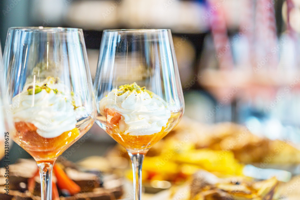 Dessert in Glass with Whipped Cream, Orange and Pistachio, Close-up View Dessert in Glass with Whipped Cream, Orange and Pistachio, Close-up View