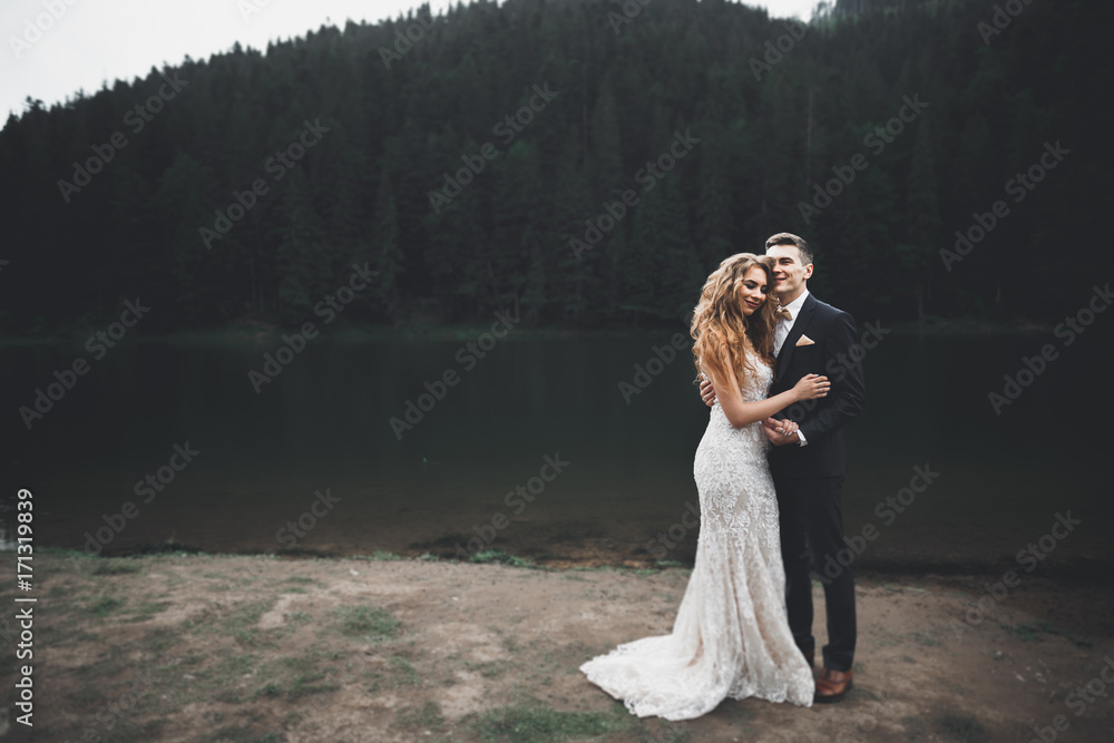 Beautiful gorgeous bride posing to groom and having fun, luxury ceremony at mountains with amazing view, space for text, wedding couple Beautiful gorgeous bride posing to groom and having fun, luxury ceremony at mountains with amazing view, space for text, wedding couple
