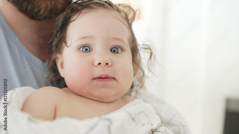 Happy family mother father and baby after bathing Happy family mother father and baby after bathing