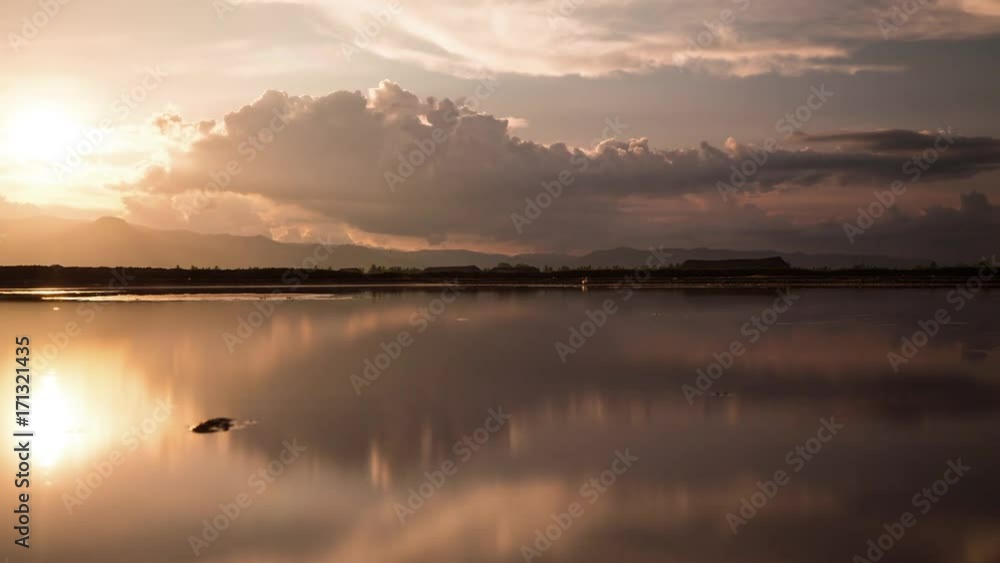 Mirror image cloud reflections at sunset on the salt fields of the south east Asia Monsoon season Mirror image cloud reflections at sunset on the salt fields of the south east Asia Monsoon season