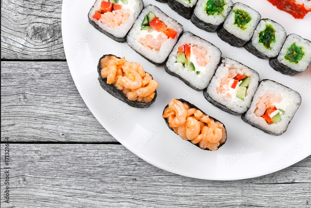 Colorful set of sushi and rolls top view on wood, closeup Colorful set of sushi and rolls top view on wood, closeup
