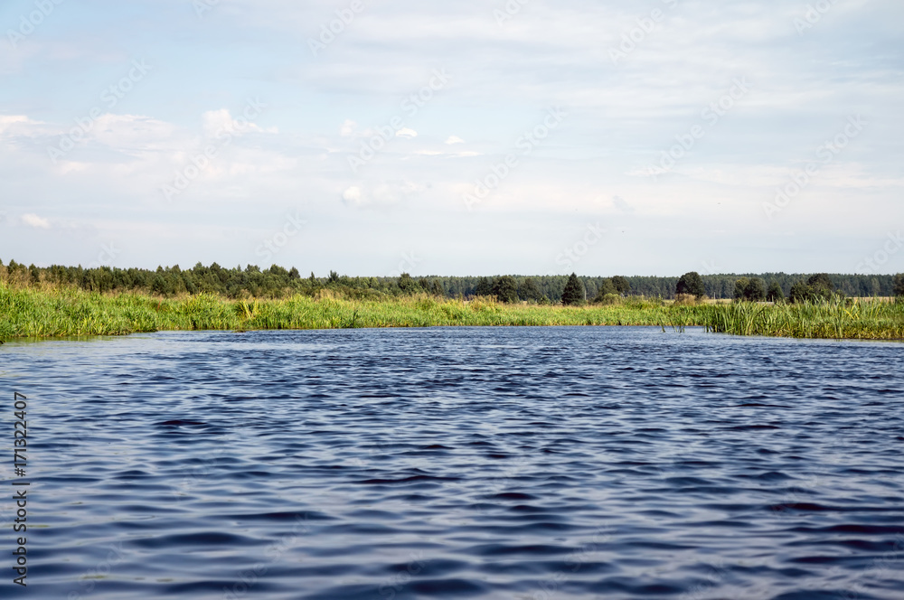 Blue ripples on the surface of the water against the blue sky. Blue ripples on the surface of the water against the blue sky.