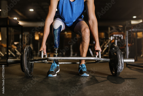 Disabled young man training in the gym.