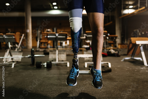 Close up of prosthesis leg of young man training in the gym.