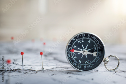 Retro compass on ancient map background. Travel geography navigation concept background.