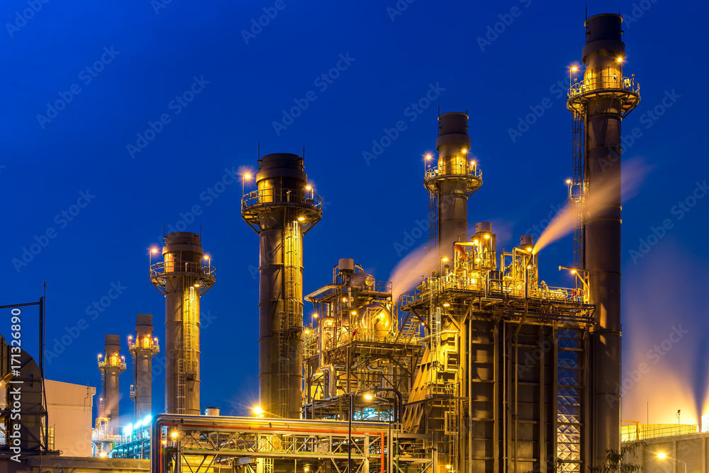 Oil refinery building plant and construction site at twilight with blue sky background