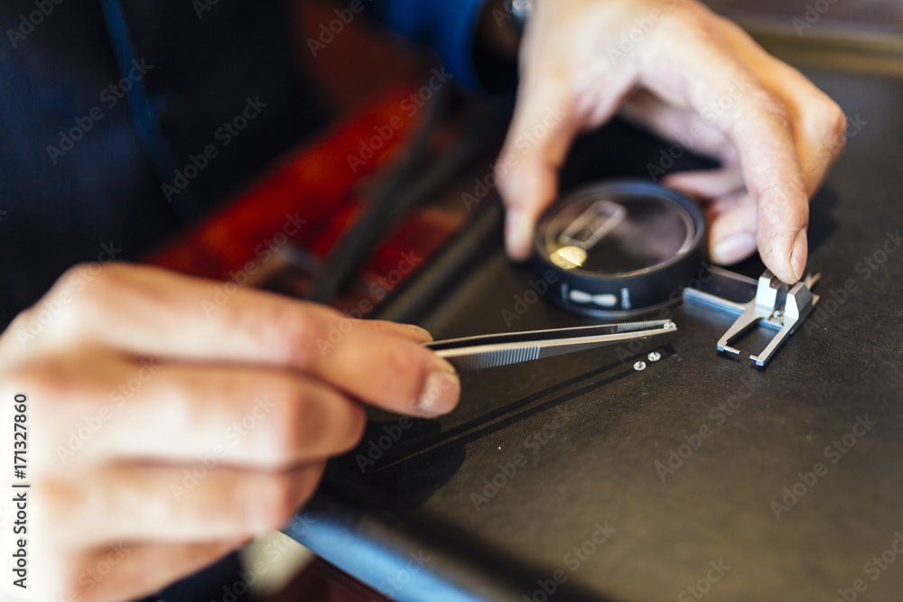 Jeweler checking size of diamond Jeweler checking size of diamond