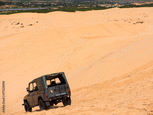 Jeep car on Yellow sand dunes in Mui Ne is a popular tourist destination of Vietnam