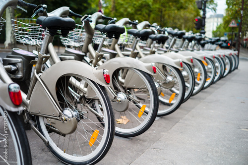 Принти на полотні A fleet of shared bicycles neatly lined-up in a row at a docking station