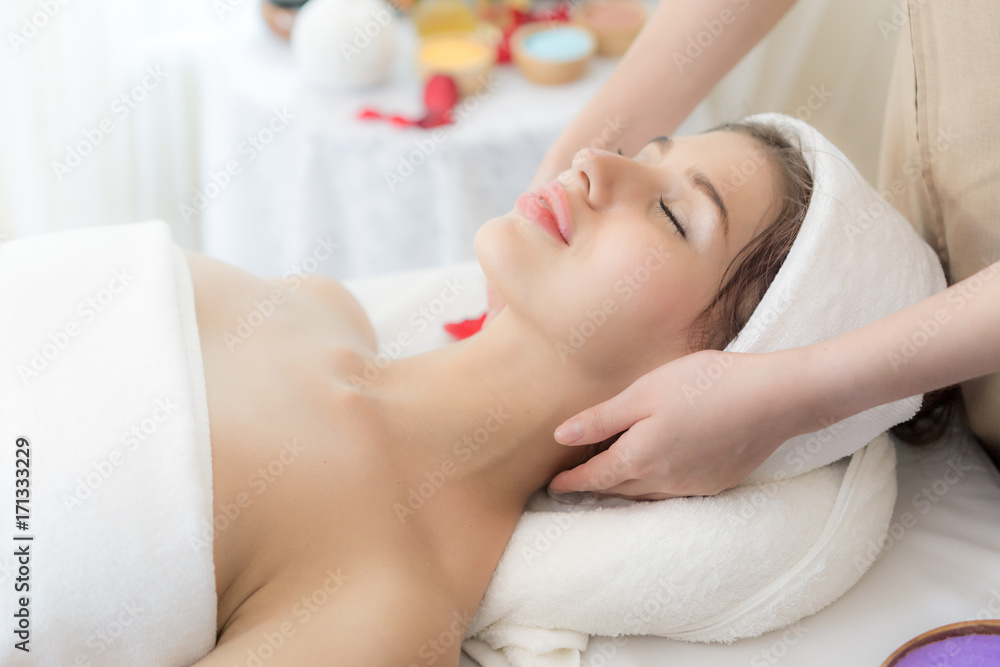 beautiful and healthy young woman relaxing with massage  at beauty spa salon
