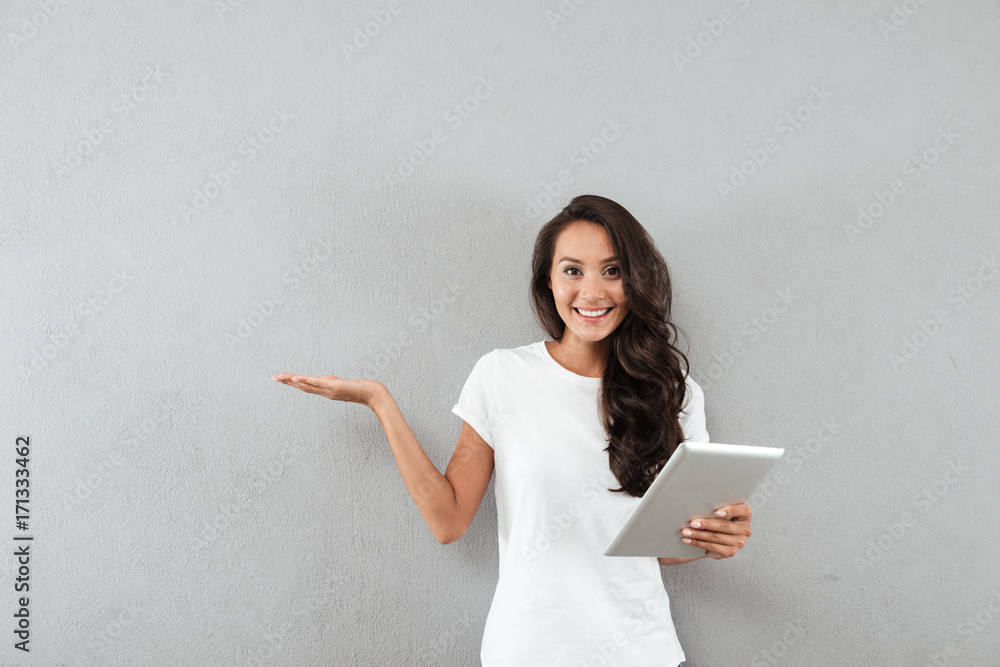 Smiling pretty asian woman holding tablet computer Smiling pretty asian woman holding tablet computer