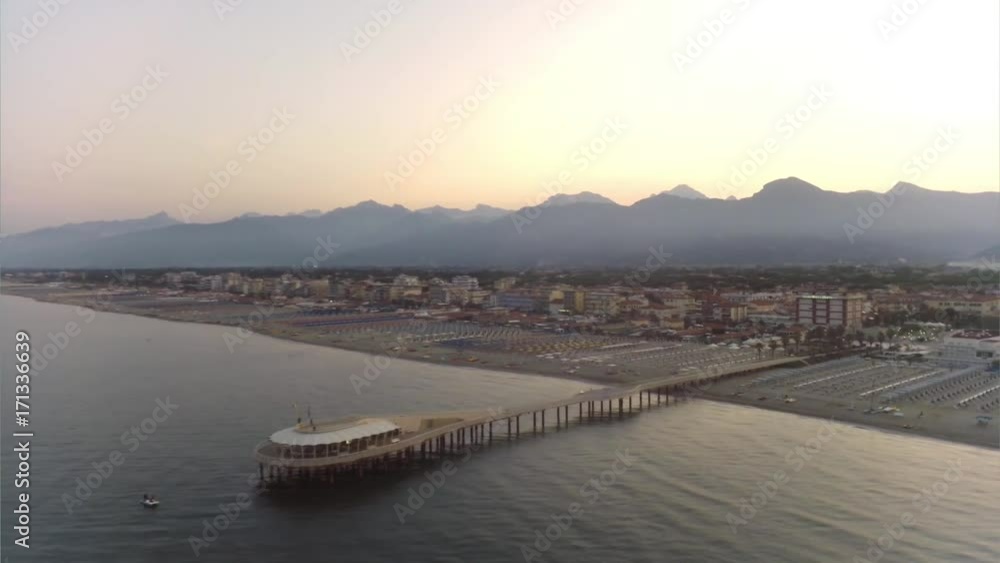 Aerial view of the coastline of versilia at sunrise,tuscany,Italy, In the foreground the pier of Lido's di camaiore, and the apian alps in the background
Aerial view of the coastline of versilia at sunrise,tuscany,Italy, In the foreground the pier of Lido's di camaiore, and the apian alps in the background