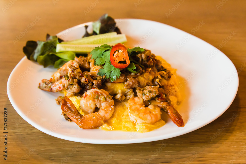 Spicy fried rice with shrimp and egg on white dish Spicy fried rice with shrimp and egg on white dish