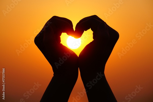 Love  heart sign gesture on the sunset  silhouette of heart with heands