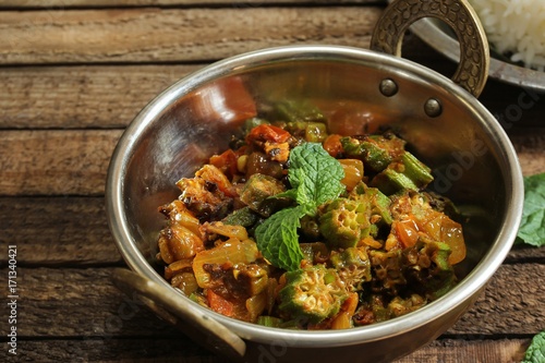 Bhindi Masala or Fry  / Okra cooked with onions tomatoes and spices photo