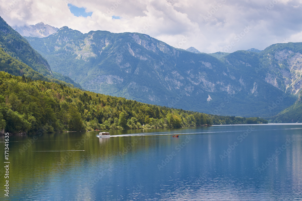 View of lake Bohinj in Slovenia with the ship sailing across it