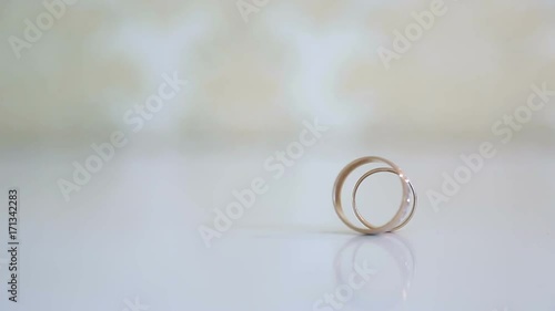 Unique case. Two wedding rings hit one another and fall one on one.