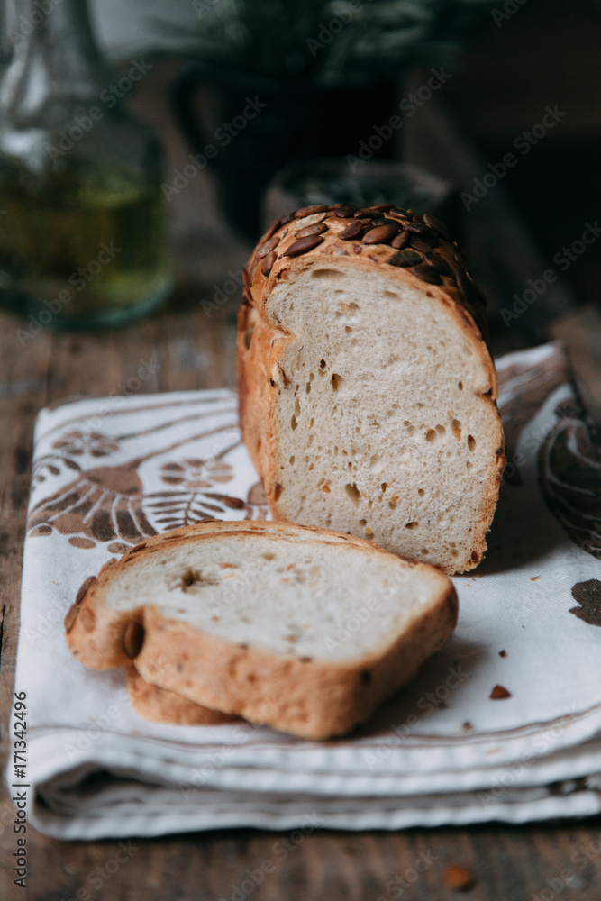Sliced bread with butter on wooden background and the scattered seeds. Sliced bread with butter on wooden background and the scattered seeds.