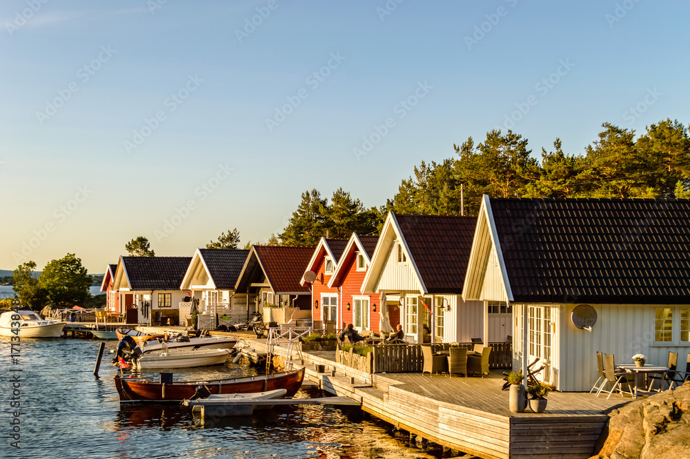 Houses along the small harbor in Norway. Sunset mood Houses along the small harbor in Norway. Sunset mood