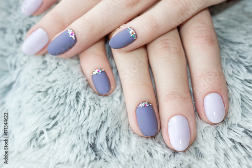 Serenity manicure with diamonds. Shaggy background