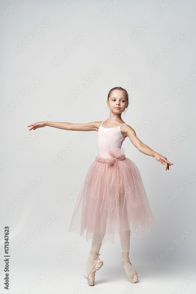 Naklejka premium little ballerina in a pink tutu dancing