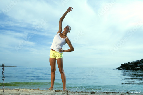 Beauty girl doing sport exercises outdoors