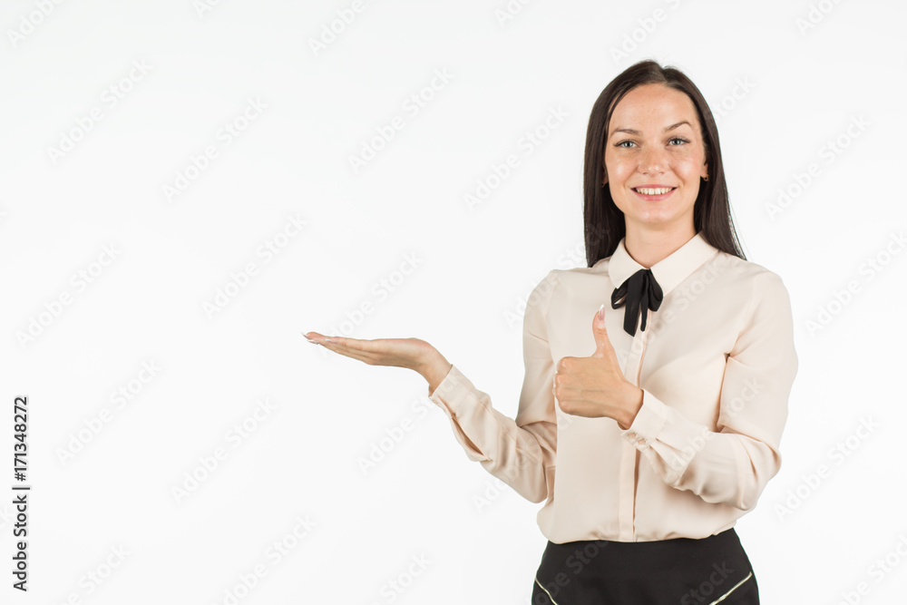 Young beautiful woman points to the object on the left / right. The girl smiles and points to the side. An attractive business lady is advertising something. Place for your text. Young beautiful woman points to the object on the left / right. The girl smiles and points to the side. An attractive business lady is advertising something. Place for your text.