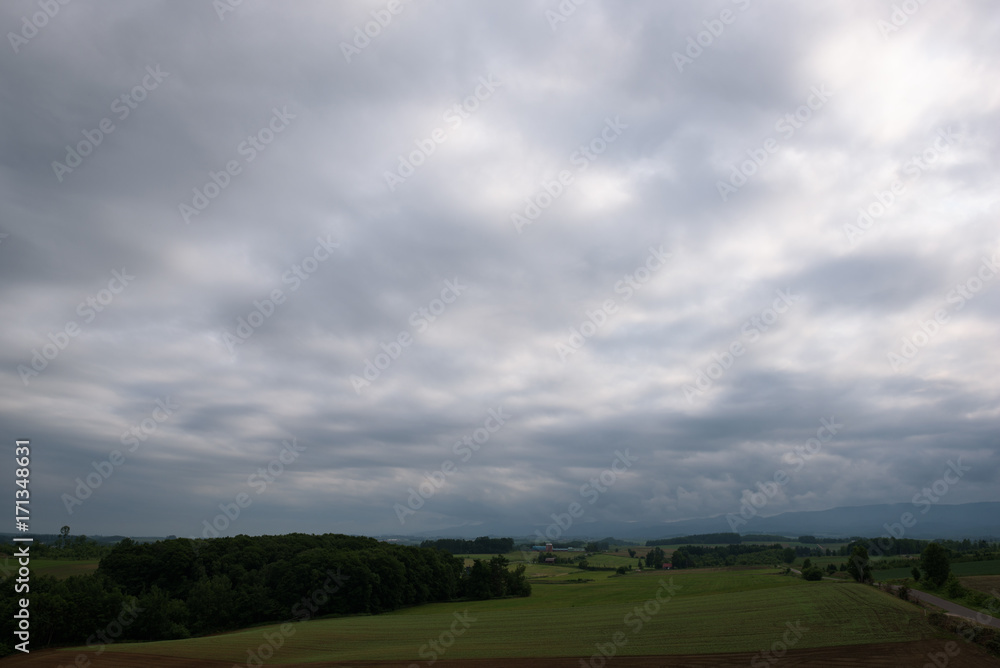 Beautiful rural landscape around Biei under a cloudy sky, Biei, Hokkaido, Japan