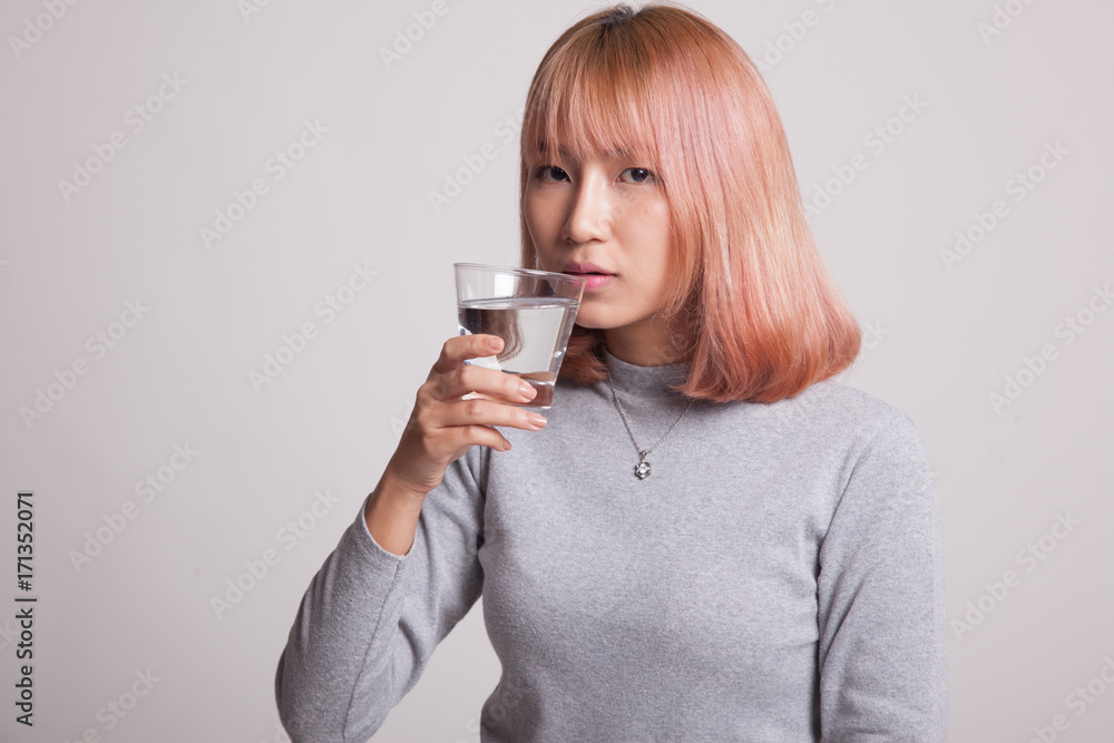 Young Asian woman with a glass of drinking water. Young Asian woman with a glass of drinking water.