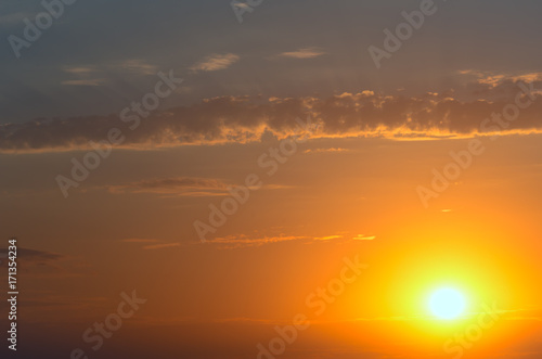 A fiery large sun and a cloud with rays. © Sviatoslav Khomiakov