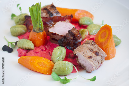 Pork tenderloin with beetroot souce, carrots and gnocchi.