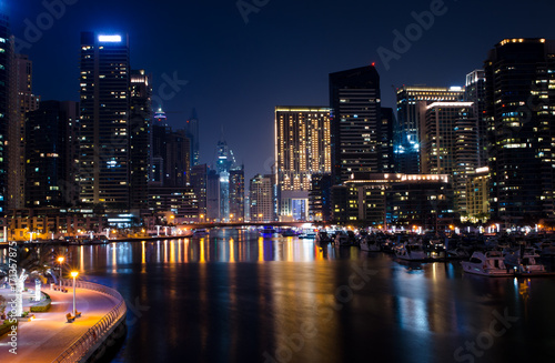Landscape of illuminated skyscrapers with reflection in water night