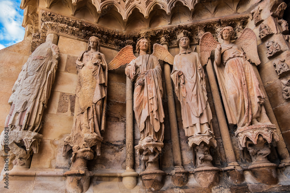 Famous Smiling angel (right) on facade of Notre-Dame de Reims Cathedral (Our Lady of Reims, 1275). Reims, Champagne-ardenne, France.