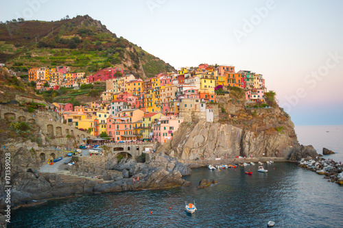 Beautiful view of Manarola one of five famous colorful villages of Cinque Terre National Park in Italy on sheer cliffs, Unesco famous colorful villages in Cinque Terre, Liguria Italy.