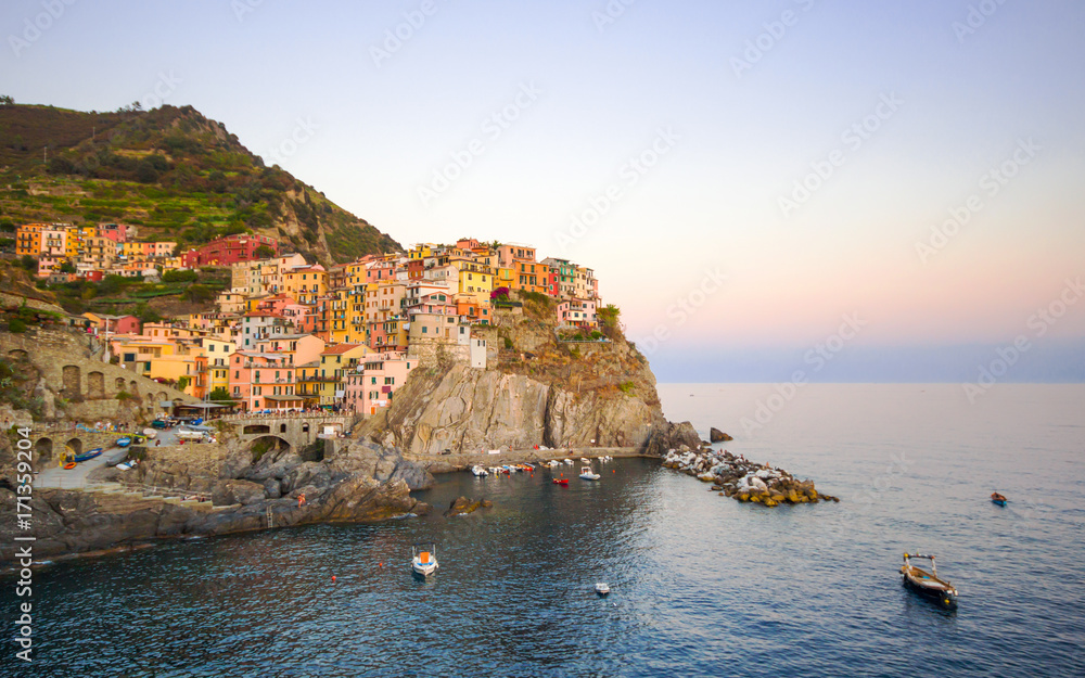 Beautiful view of Manarola one of five famous colorful villages of Cinque Terre National Park in Italy on sheer cliffs, Unesco famous colorful villages in Cinque Terre, Liguria Italy.