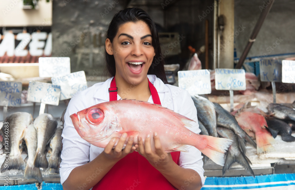 Laughing woman selling fresh fish on a latin fish market Stock Photo ...