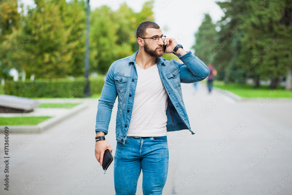 Handsome fashionable fit man talking over telephone