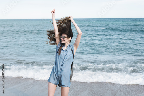 Young wild and free woman at the sea