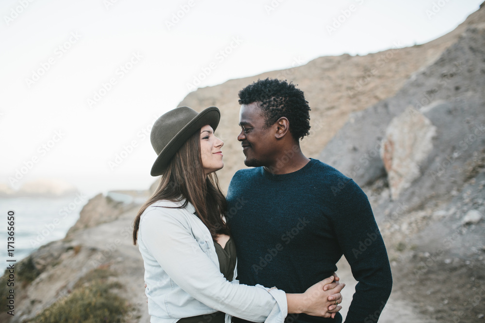 couple together on path in front of rocky landscape couple together on path in front of rocky landscape