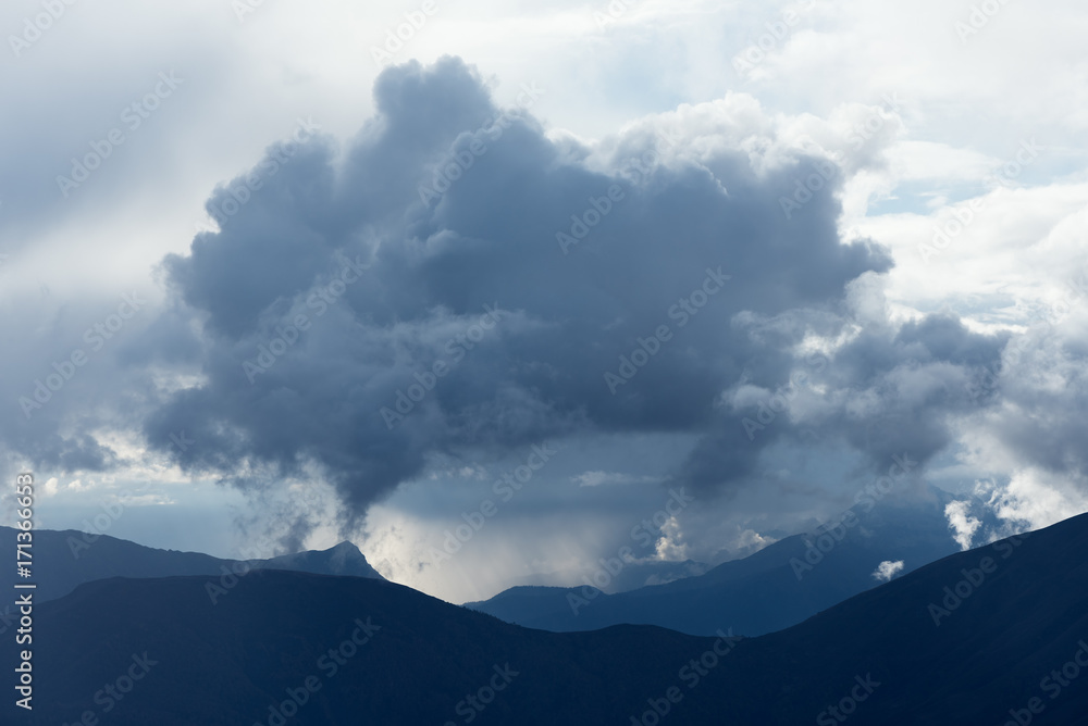 Mountain top and cumulus clouds