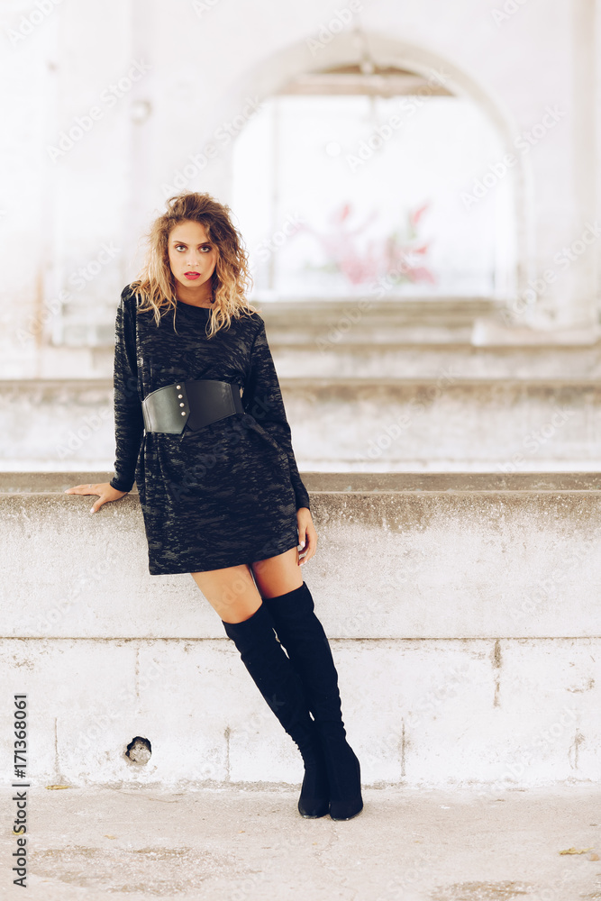 Stylish fashionable girl with blonde long hair, stylish black dress. Fashion trendy woman concept Stylish fashionable girl with blonde long hair, stylish black dress. Fashion trendy woman concept